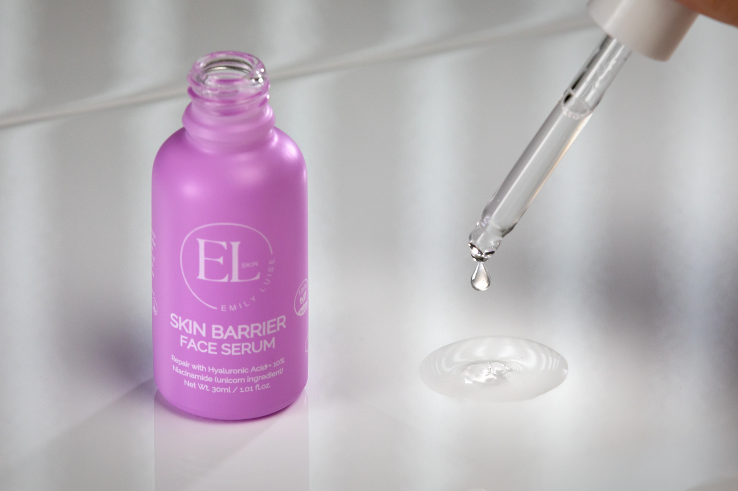Purple serum bottle with dropper on a light background