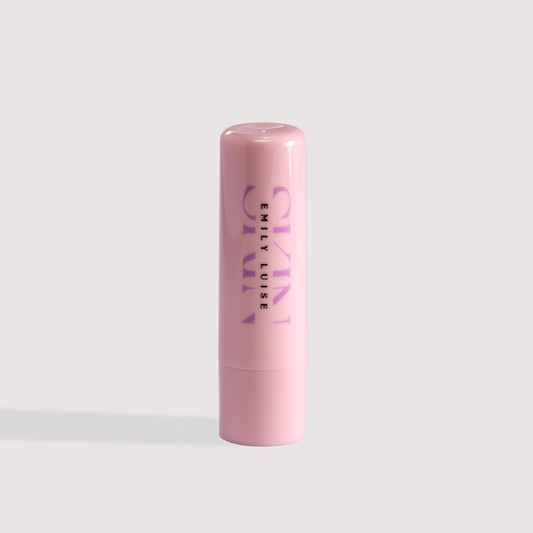Pink lip balm with 'EMILY LUISE' branding on a light gray background