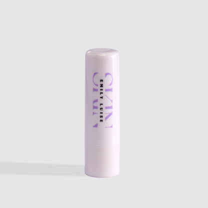 Lip balm with 'emily luise ' branding on a light gray background